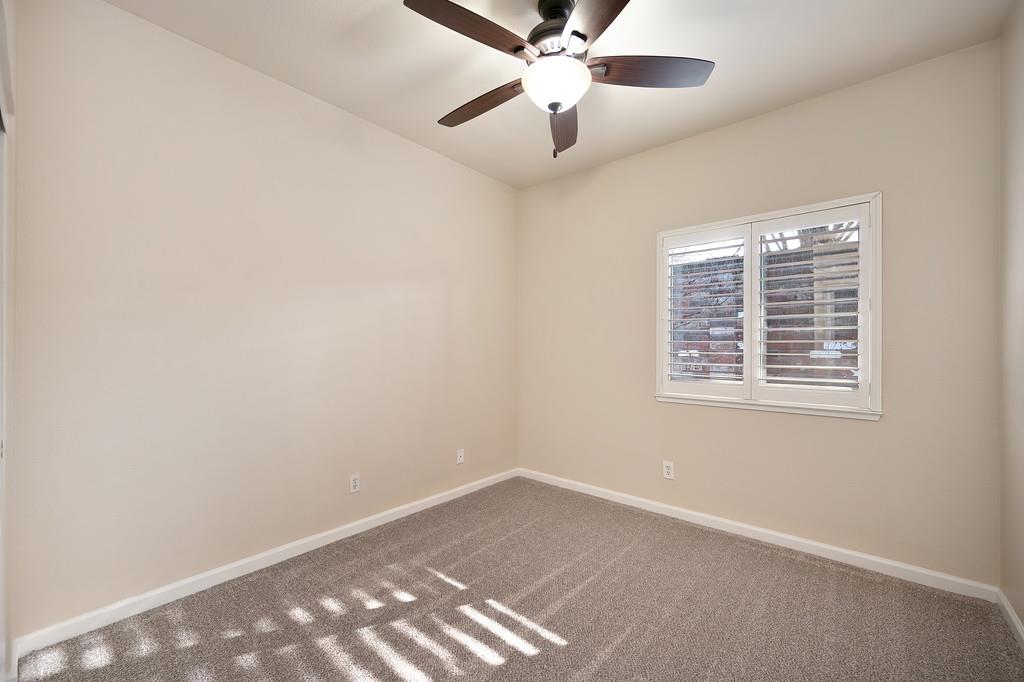 9594 Prost Court Elk Grove, CA 95758 - Photo 34 of 46 an empty room with a window and a fan