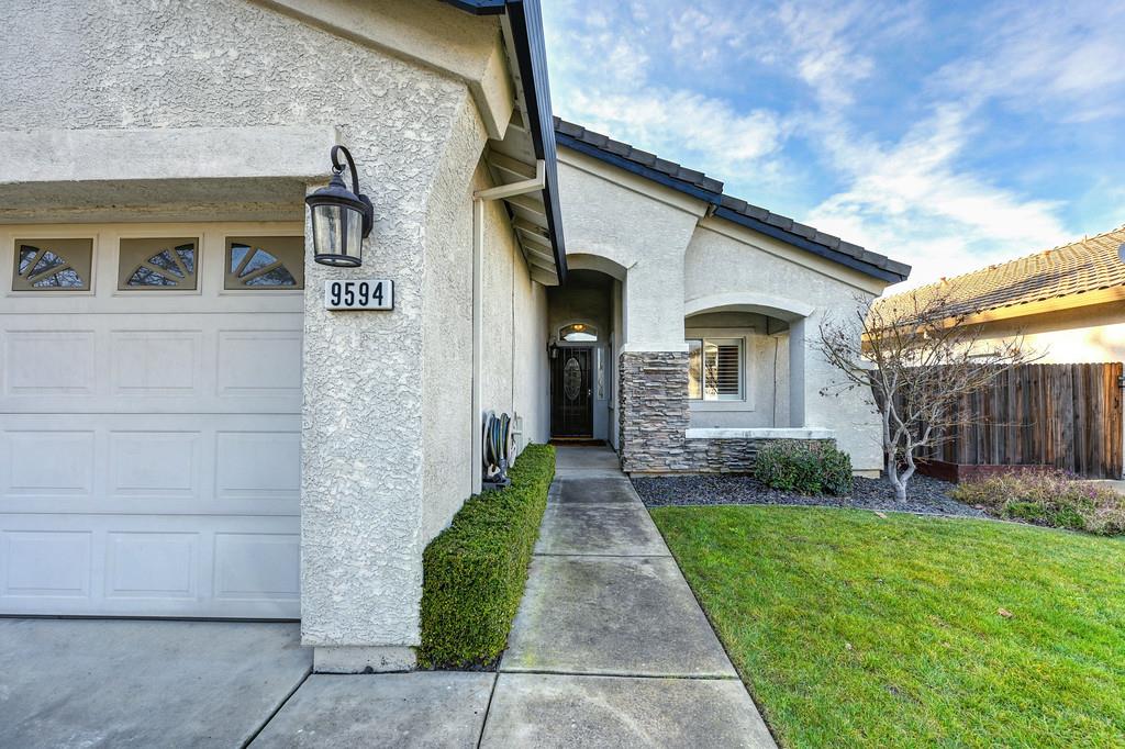 9594 Prost Court Elk Grove, CA 95758 - Photo 5 of 46 a front view of a house with garden