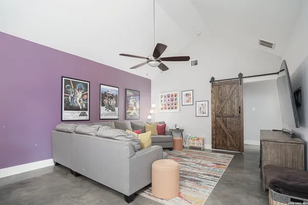 a living room with furniture and a flat screen tv