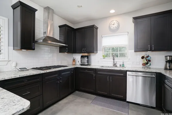 a kitchen with a sink stove top oven and cabinets