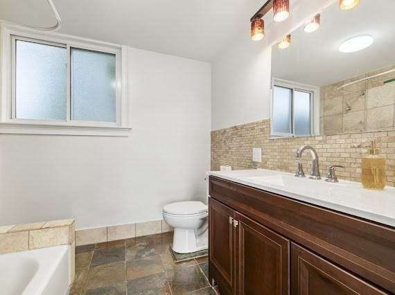 50 First Parish Road Scituate, MA 02066 - Photo 13 of 42 a bathroom with a granite countertop sink a toilet and a mirror