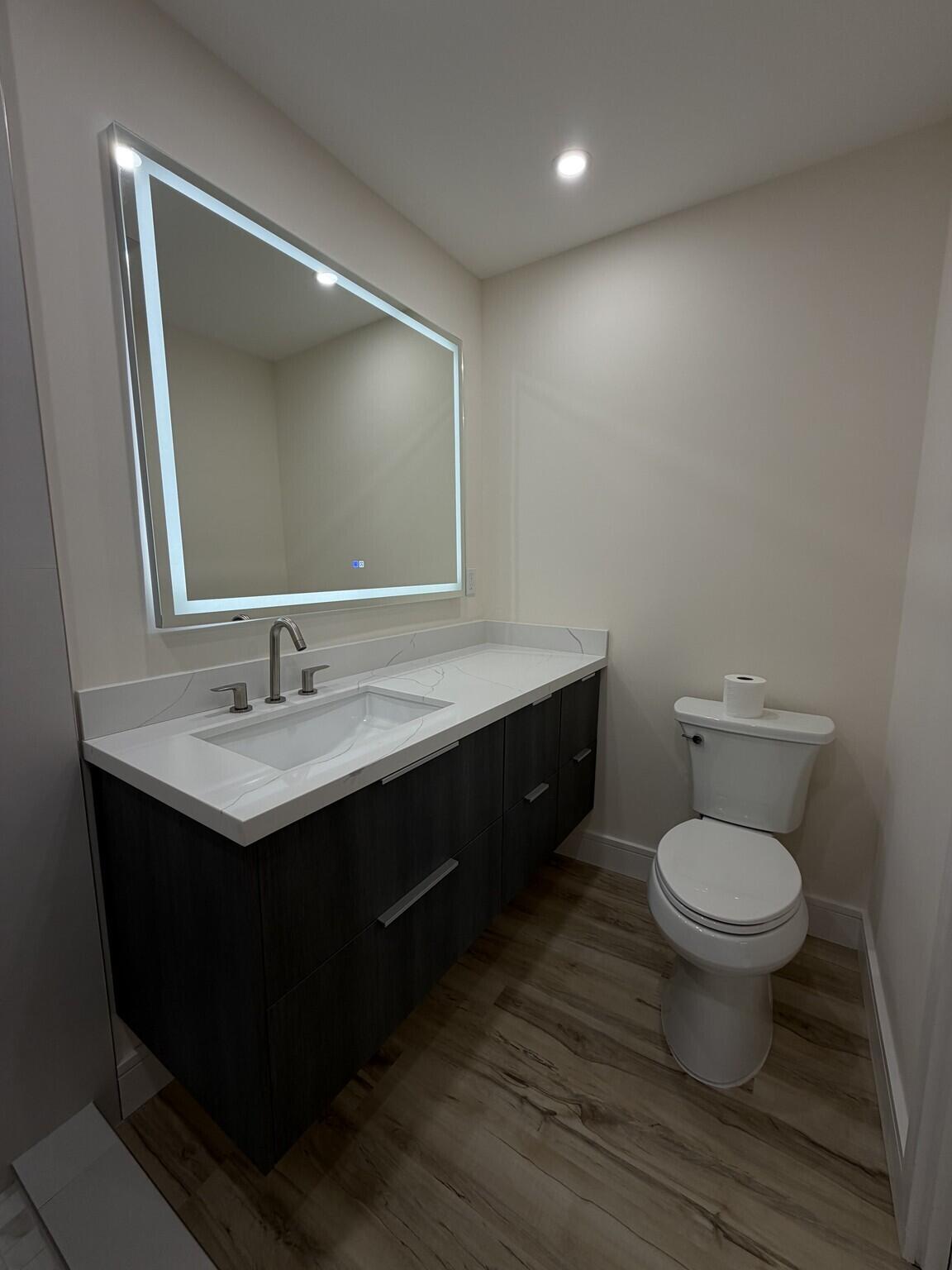 705 Banks Road Margate, FL 33063 - Photo 17 of 44 a bathroom with a toilet sink and mirror