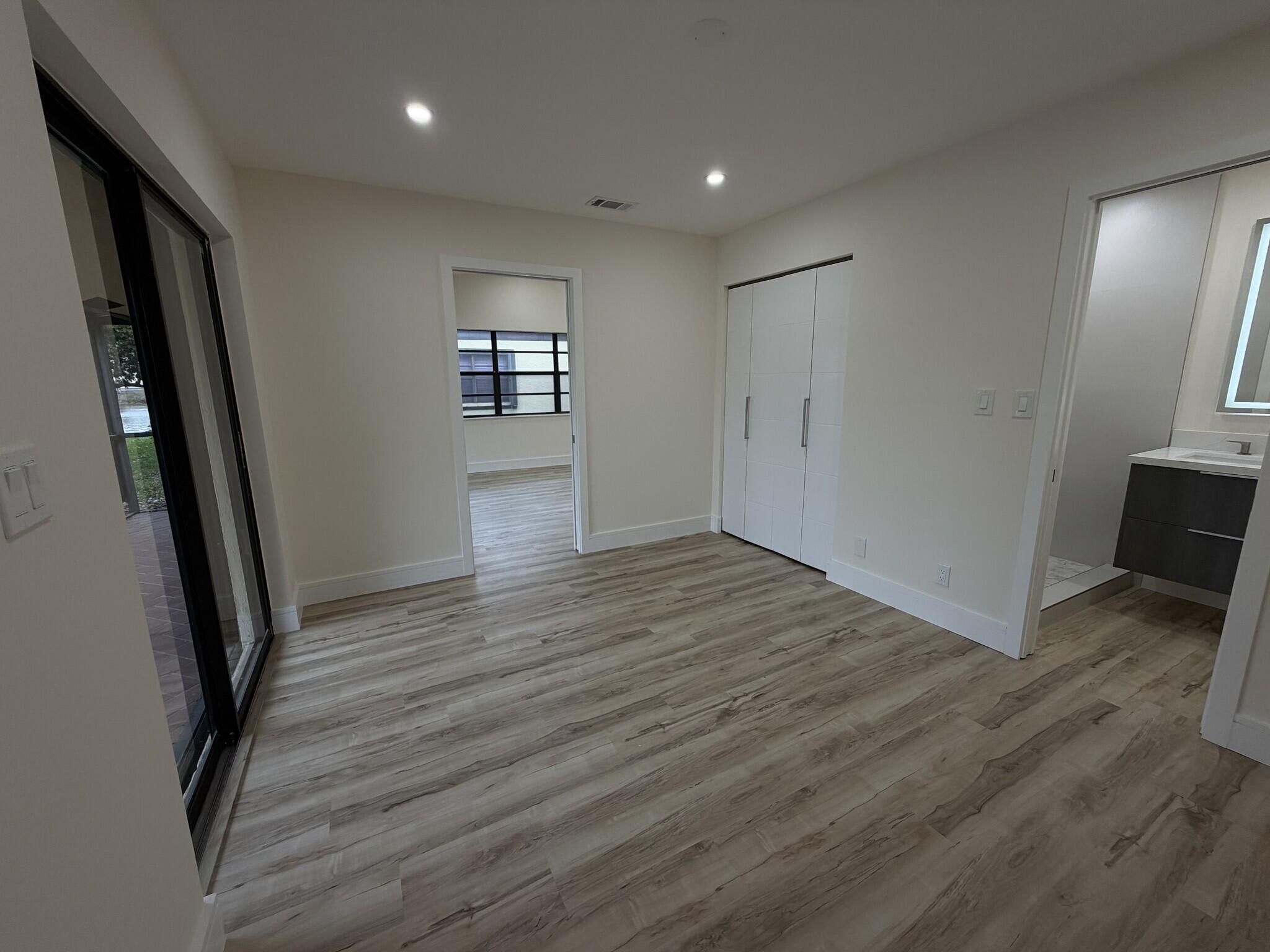 705 Banks Road Margate, FL 33063 - Photo 19 of 44 wooden floor in an empty room with a mirror