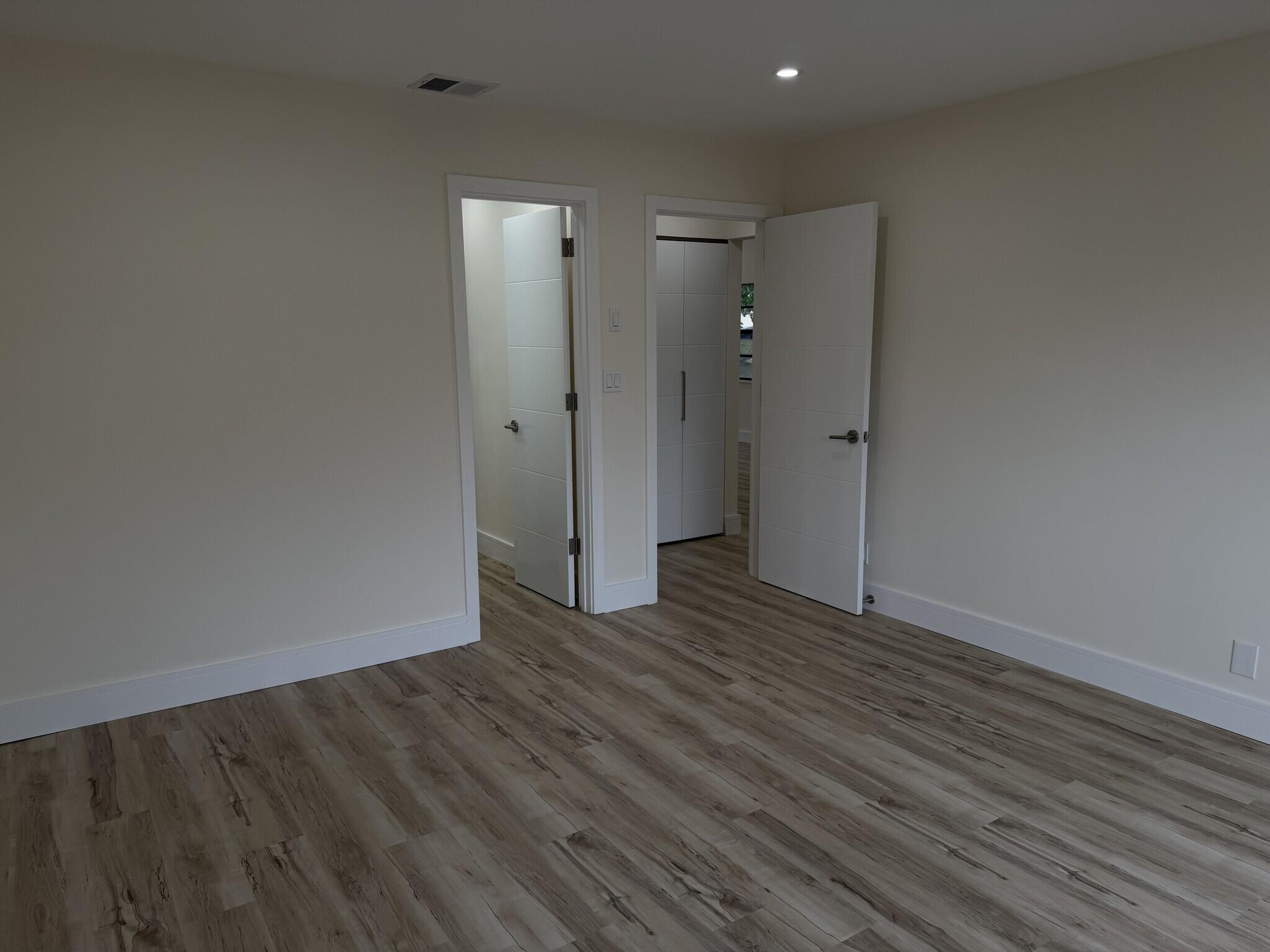 705 Banks Road Margate, FL 33063 - Photo 24 of 44 a view of an empty room with wooden floor and a window