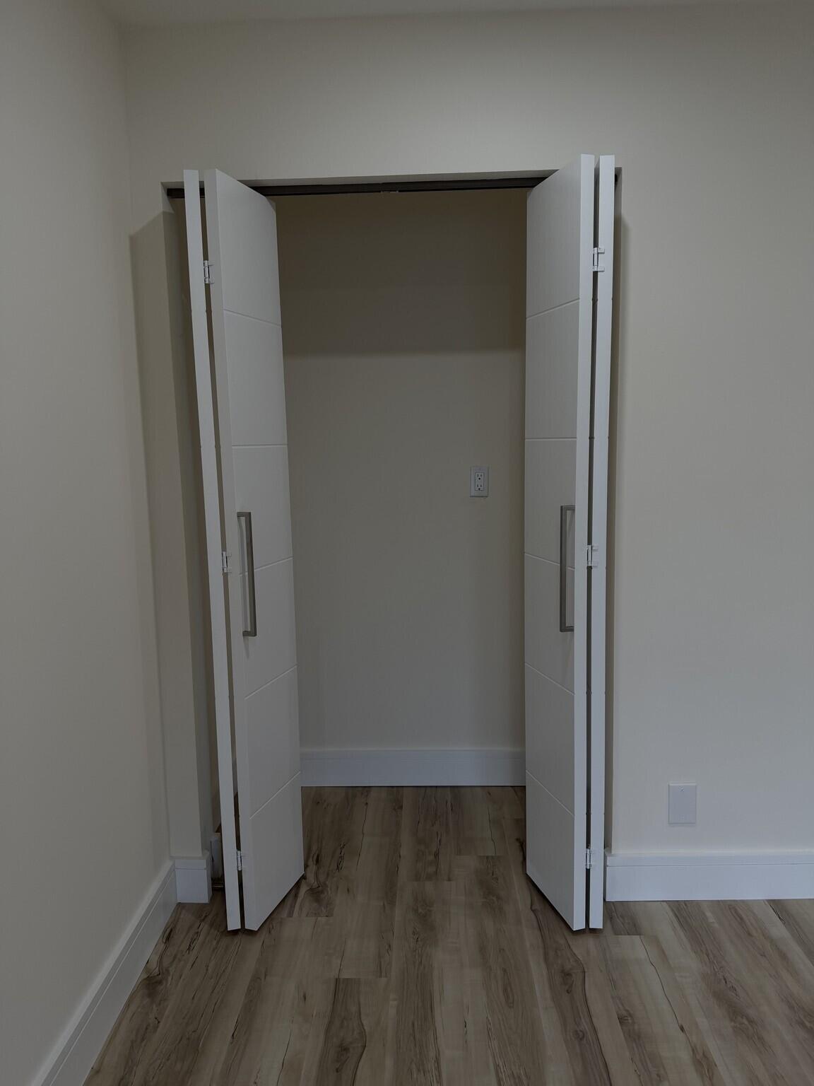705 Banks Road Margate, FL 33063 - Photo 32 of 44 an empty room with wooden floor and closet
