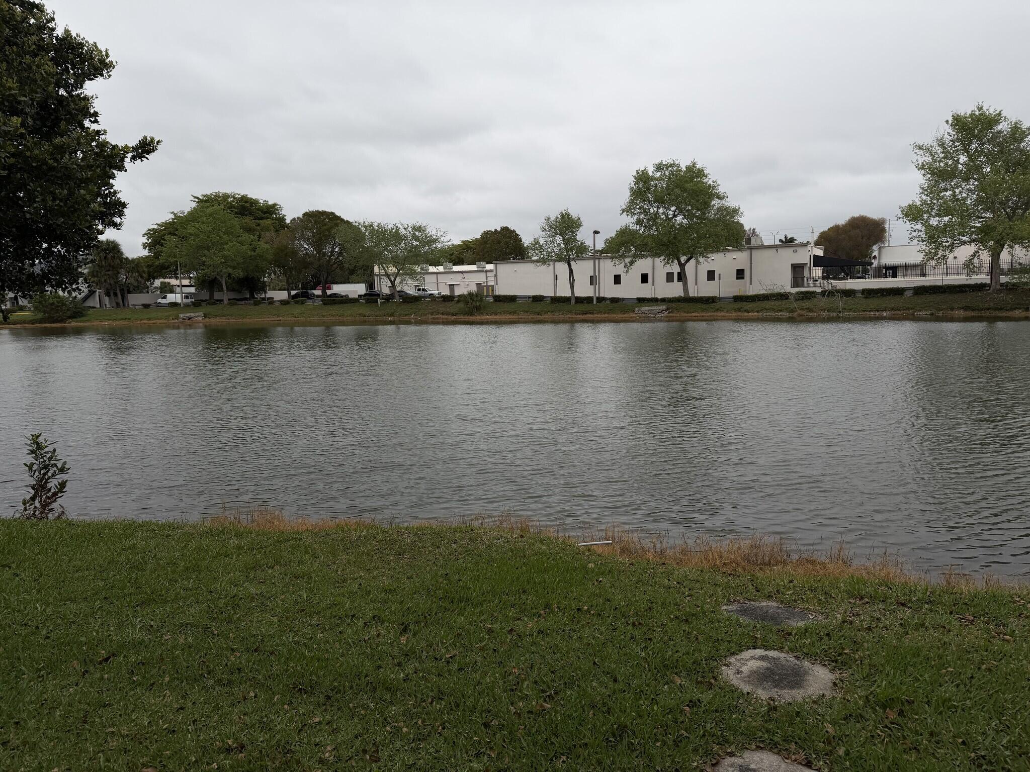 705 Banks Road Margate, FL 33063 - Photo 36 of 44 a view of a lake with houses in the background