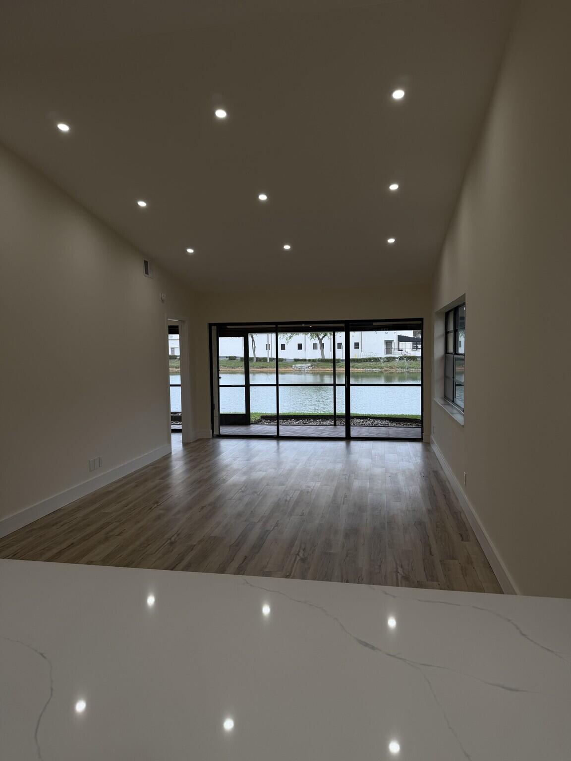 705 Banks Road Margate, FL 33063 - Photo 4 of 44 a view of empty room with wooden floor and fan