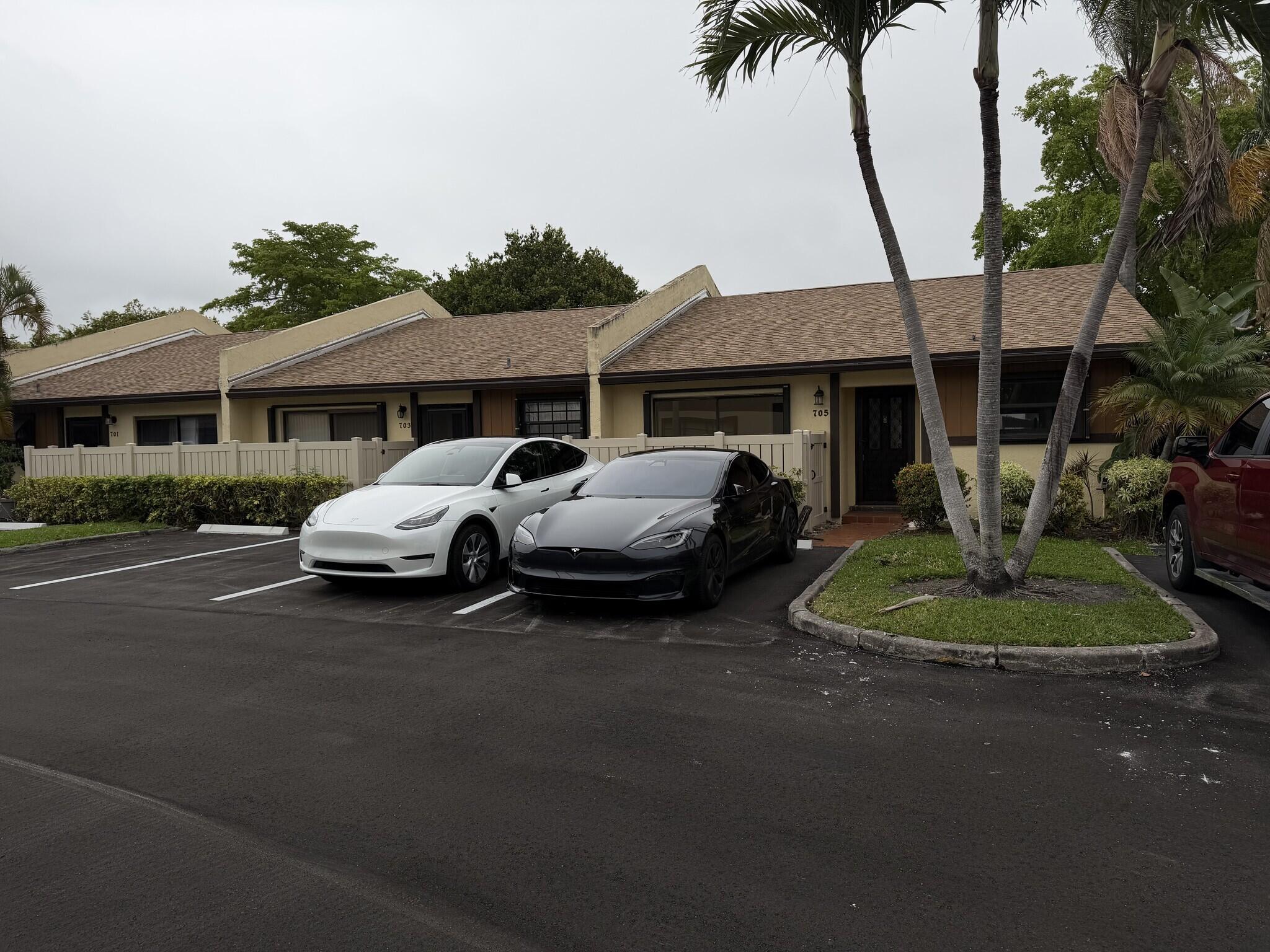 705 Banks Road Margate, FL 33063 - Photo 44 of 44 a couple of cars parked in front of a house