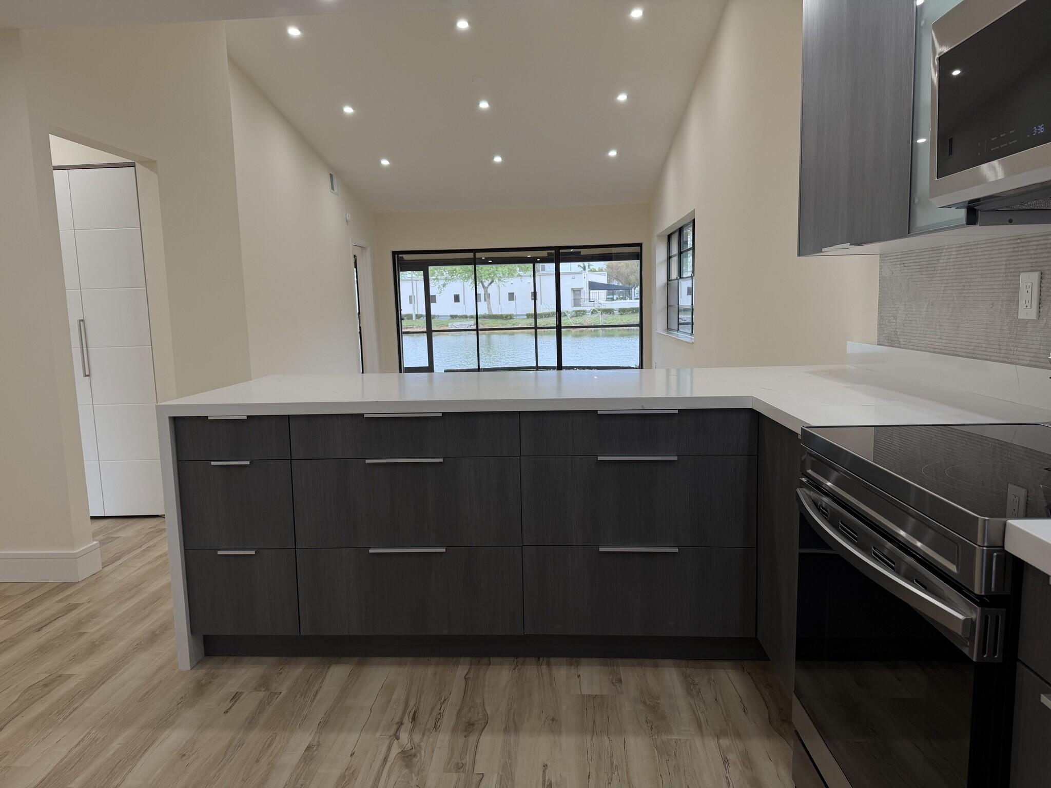705 Banks Road Margate, FL 33063 - Photo 5 of 44 a kitchen with a sink a microwave and cabinets