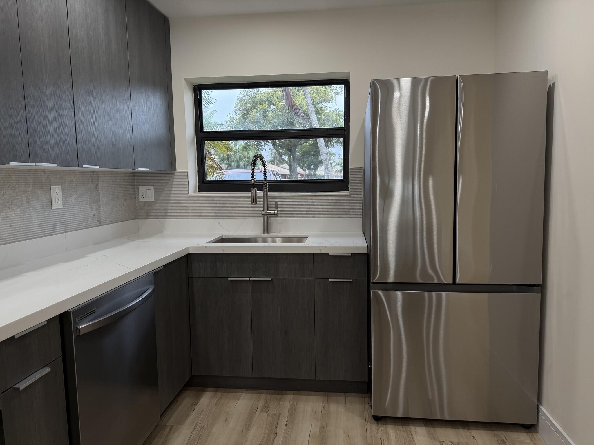 705 Banks Road Margate, FL 33063 - Photo 6 of 44 a kitchen with stainless steel appliances granite countertop a refrigerator and sink