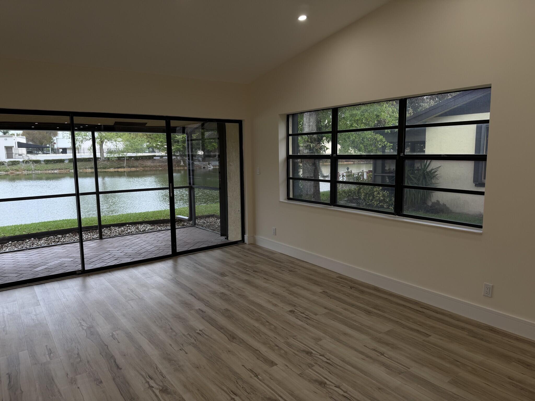705 Banks Road Margate, FL 33063 - Photo 9 of 44 a view of a room with wooden floor and windows