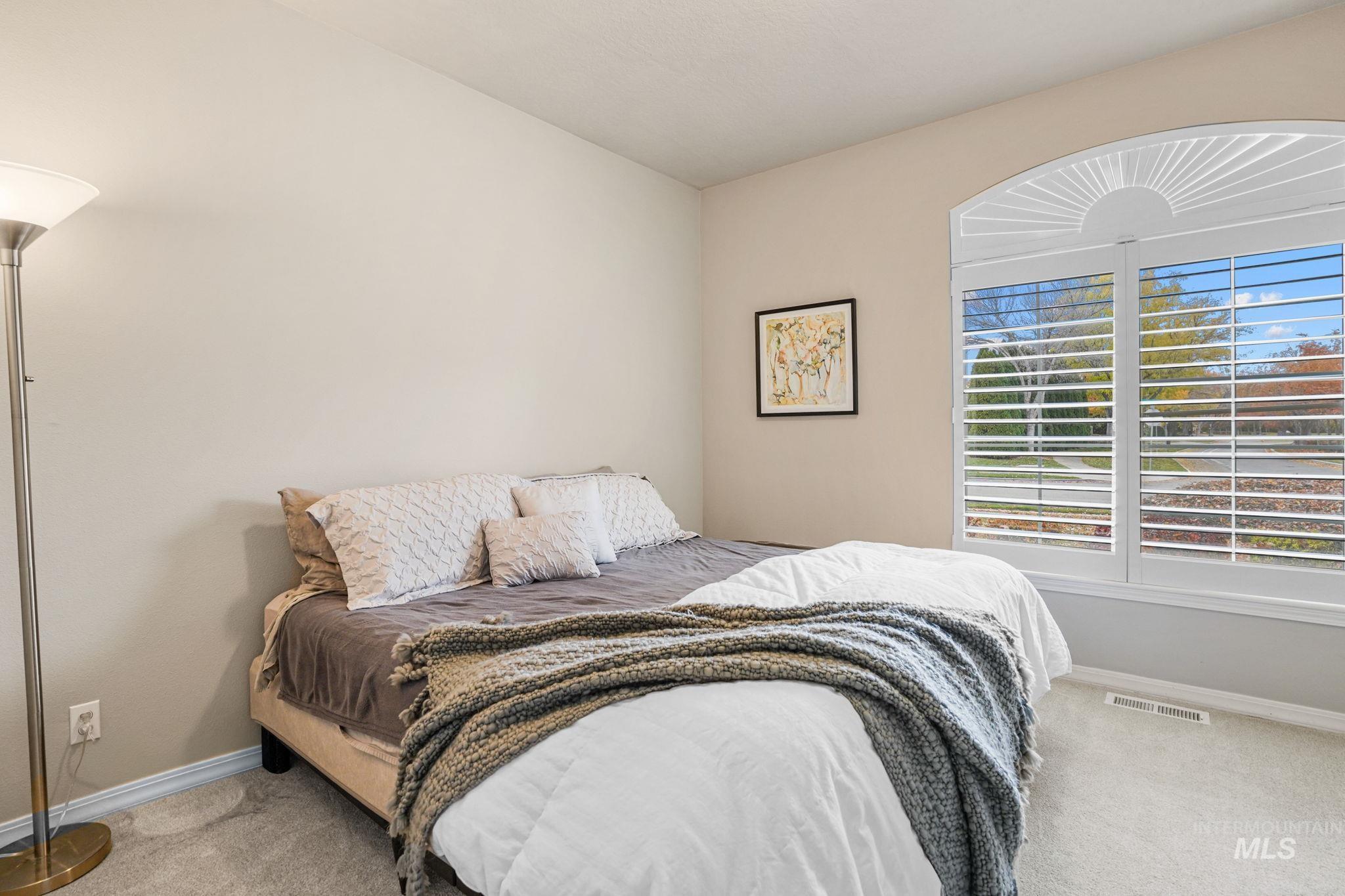 5790 North Wellspring Way Boise, ID 83713 - Photo 27 of 41 Bedroom with light colored carpet and baseboards