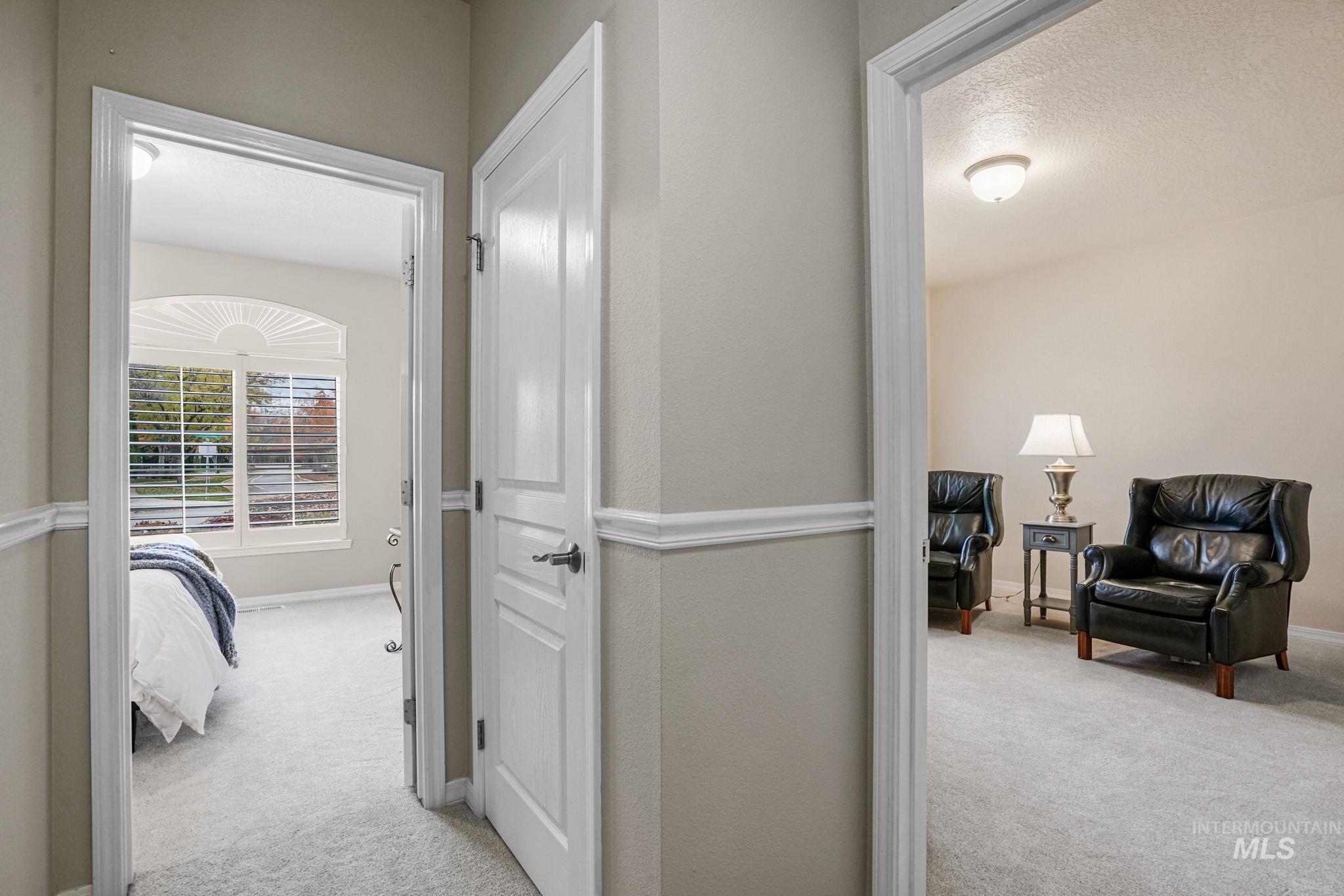 5790 North Wellspring Way Boise, ID 83713 - Photo 29 of 41 Hallway with light carpet and a textured ceiling