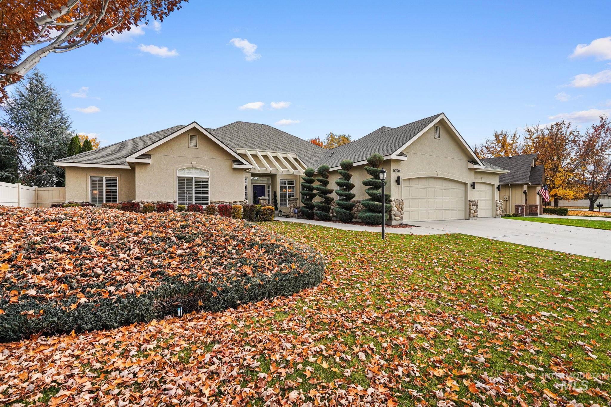 5790 North Wellspring Way Boise, ID 83713 - Photo 5 of 41 View of front of property with roof with shingles, stucco siding, concrete driveway, and an attached garage