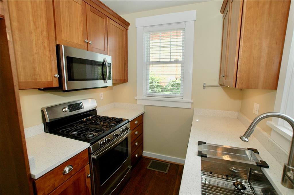 2 Dawson Court Pittsburgh, PA 15213 - Photo 8 of 34 Quartz counters, galley kitchen, stainless cooking suite with convection oven, space saving microwave