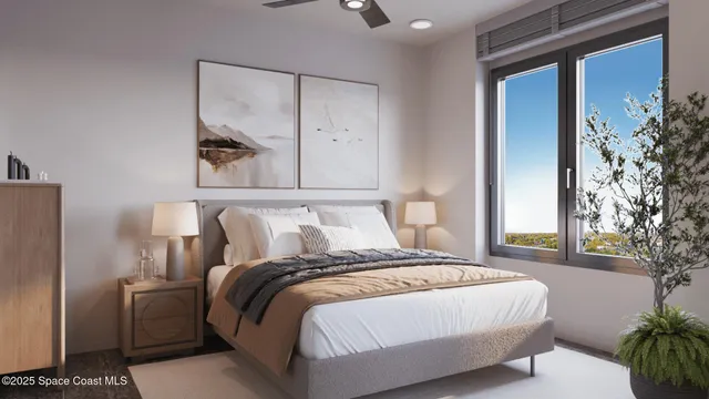 a bed sitting in a bedroom next to a window and a potted plant