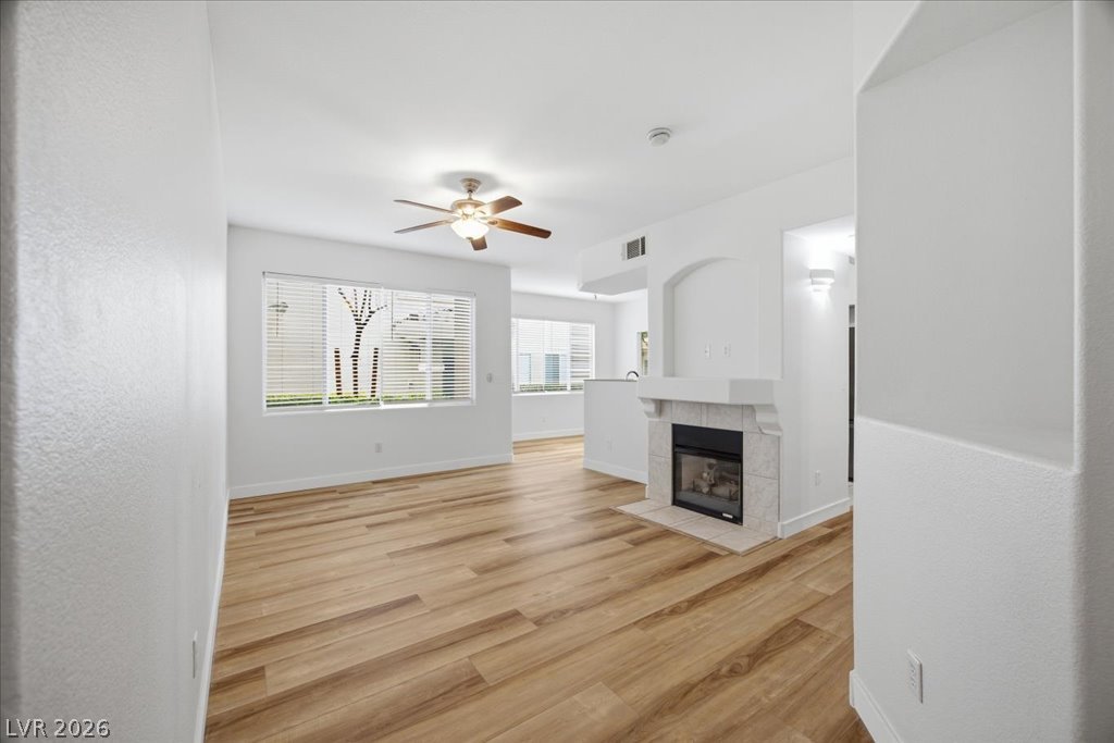 9050 West Warm Springs Road, Unit 1033 Las Vegas, NV 89148 - Photo 1 of 26 A living space offers a gas fireplace and a rich wood-tone flooring, perfect for comfortable gatherings.
