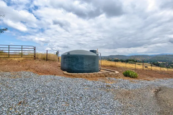 a view of house with outdoor space and sitting area