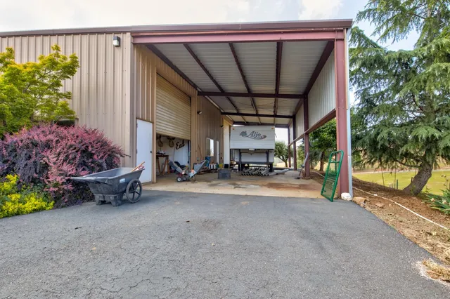 a view of a house with a yard and garage