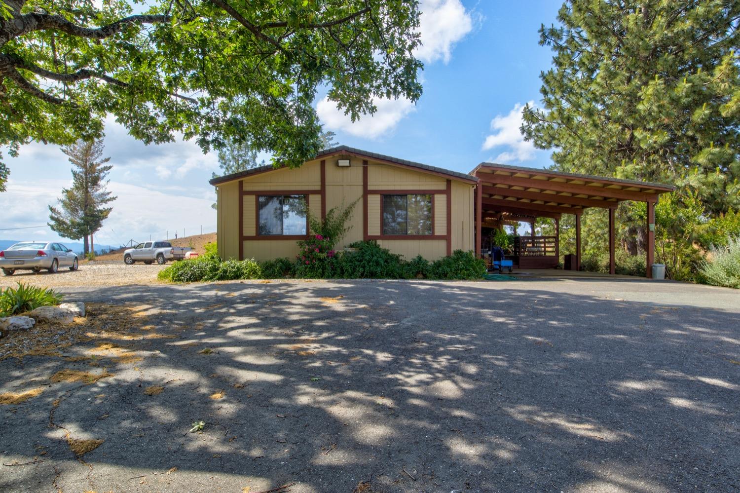 7279 Mountain Ranch Road Mountain Ranch, CA 95246 - Photo 37 of 69 a front view of a house with a yard and a garage