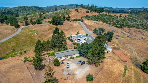 an aerial view of a house with a yard