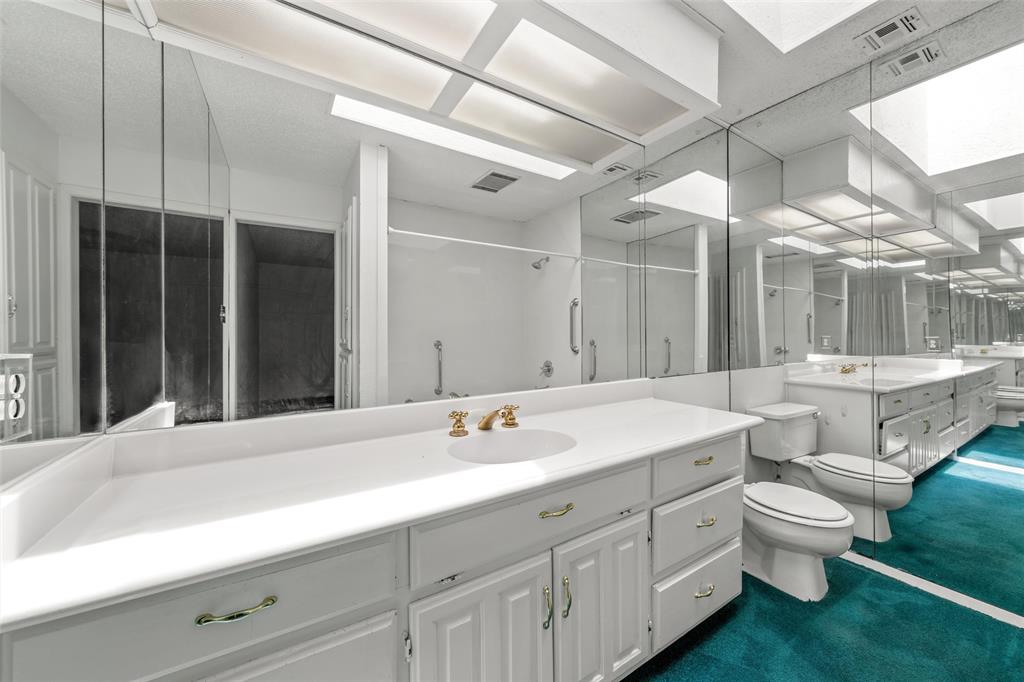7821 Tallahassee Road Woodway, TX 76712 - Photo 12 of 31 a bathroom with a double vanity sink toilet and a mirror