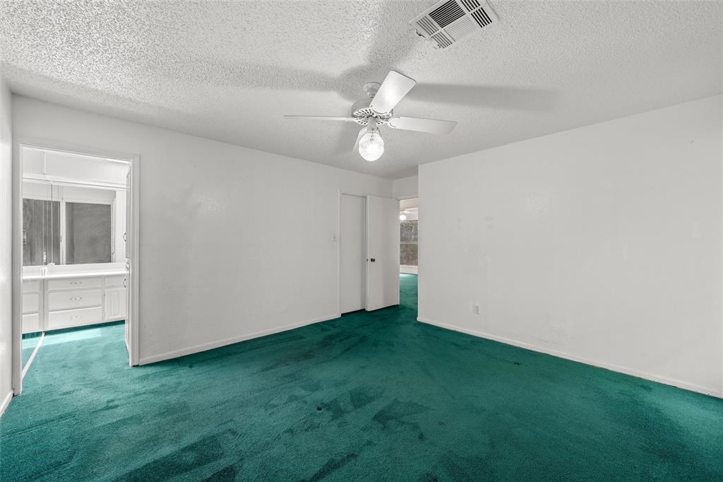 7821 Tallahassee Road Woodway, TX 76712 - Photo 14 of 31 an empty room with closet and a ceiling fan