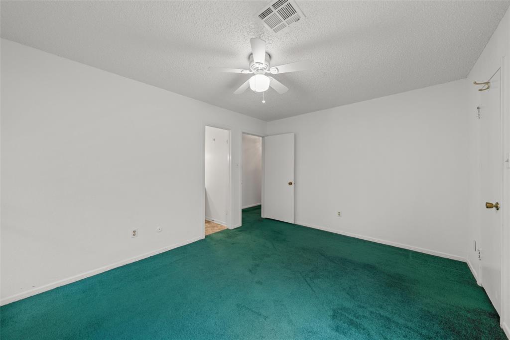 7821 Tallahassee Road Woodway, TX 76712 - Photo 15 of 31 a view of an empty room with a chandelier fan