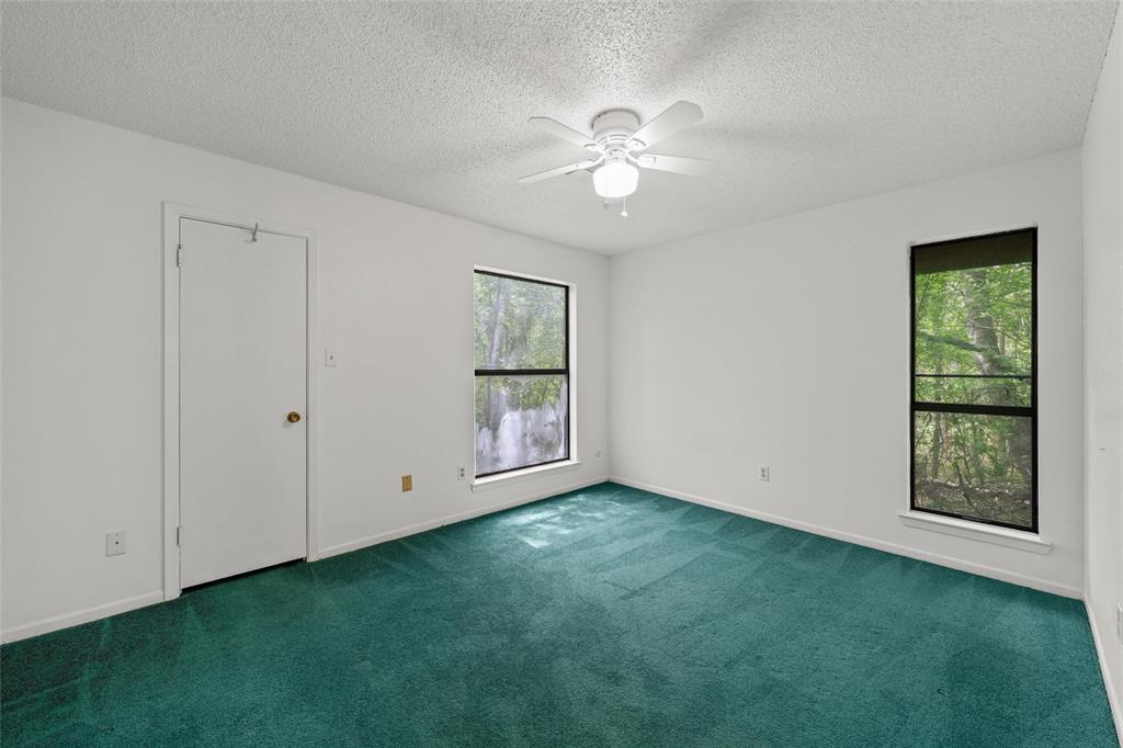 7821 Tallahassee Road Woodway, TX 76712 - Photo 16 of 31 a view of an empty room with window and chandelier fan