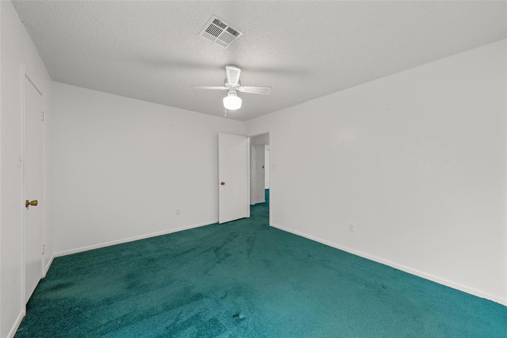 7821 Tallahassee Road Woodway, TX 76712 - Photo 17 of 31 a view of an empty room with a chandelier fan