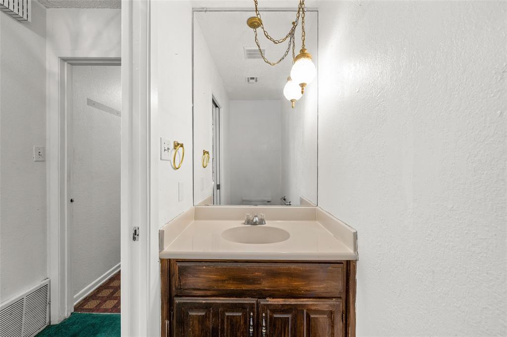 7821 Tallahassee Road Woodway, TX 76712 - Photo 20 of 31 a bathroom with a sink and a mirror
