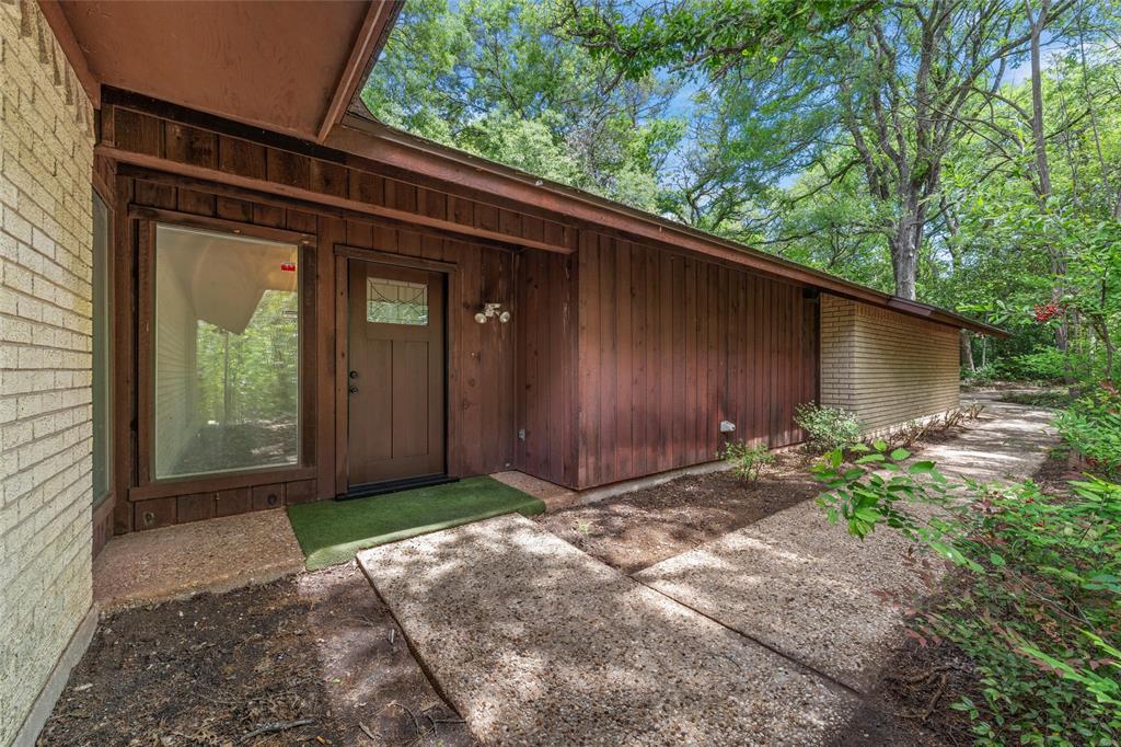 7821 Tallahassee Road Woodway, TX 76712 - Photo 2 of 31 a view of backyard with potted plants and a bench