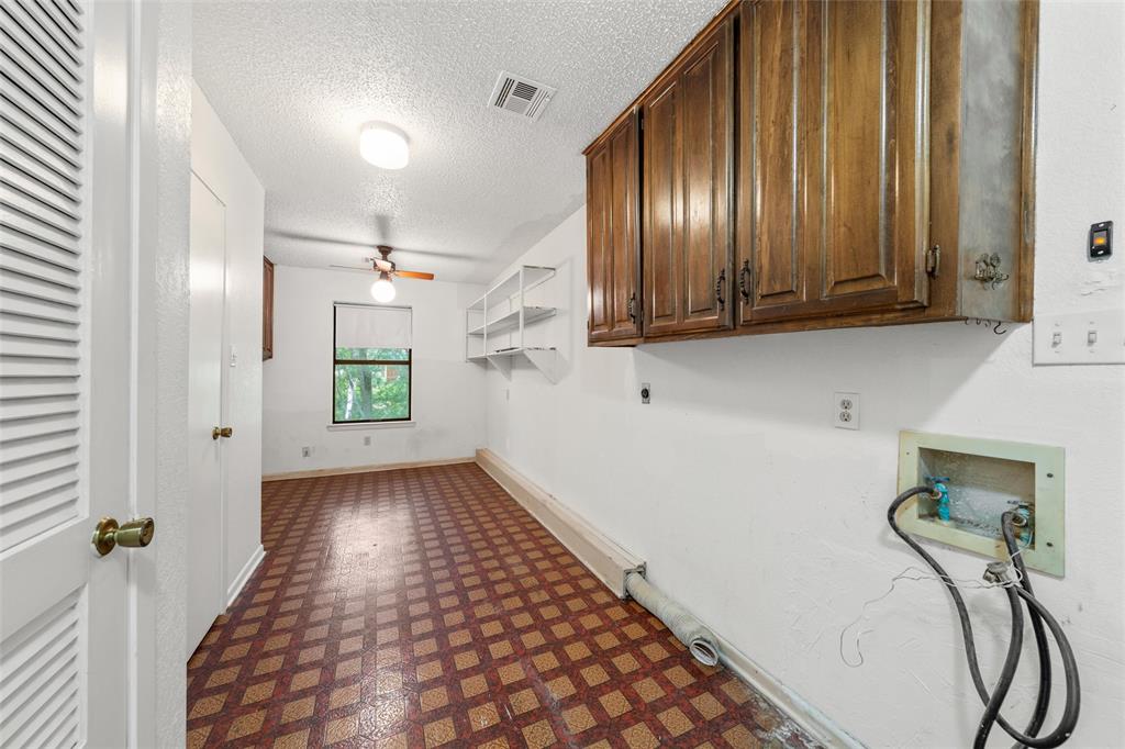 7821 Tallahassee Road Woodway, TX 76712 - Photo 22 of 31 a view of a hallway with wooden floor