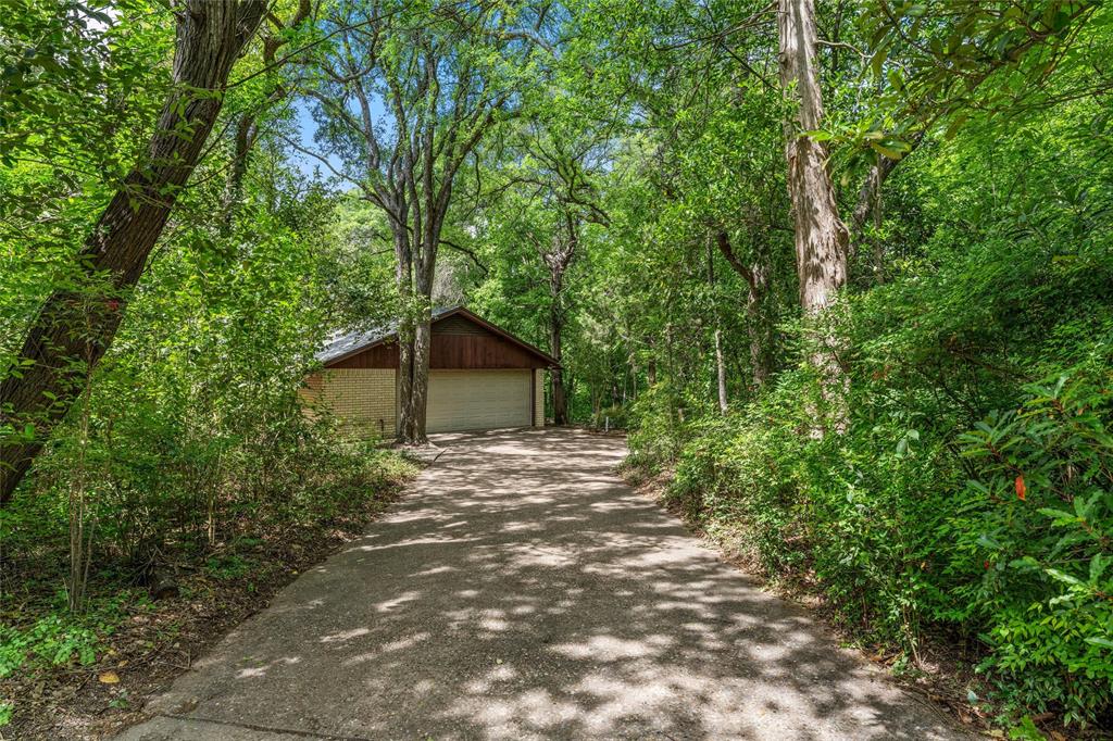 7821 Tallahassee Road Woodway, TX 76712 - Photo 27 of 31 a pathway of a house with large trees