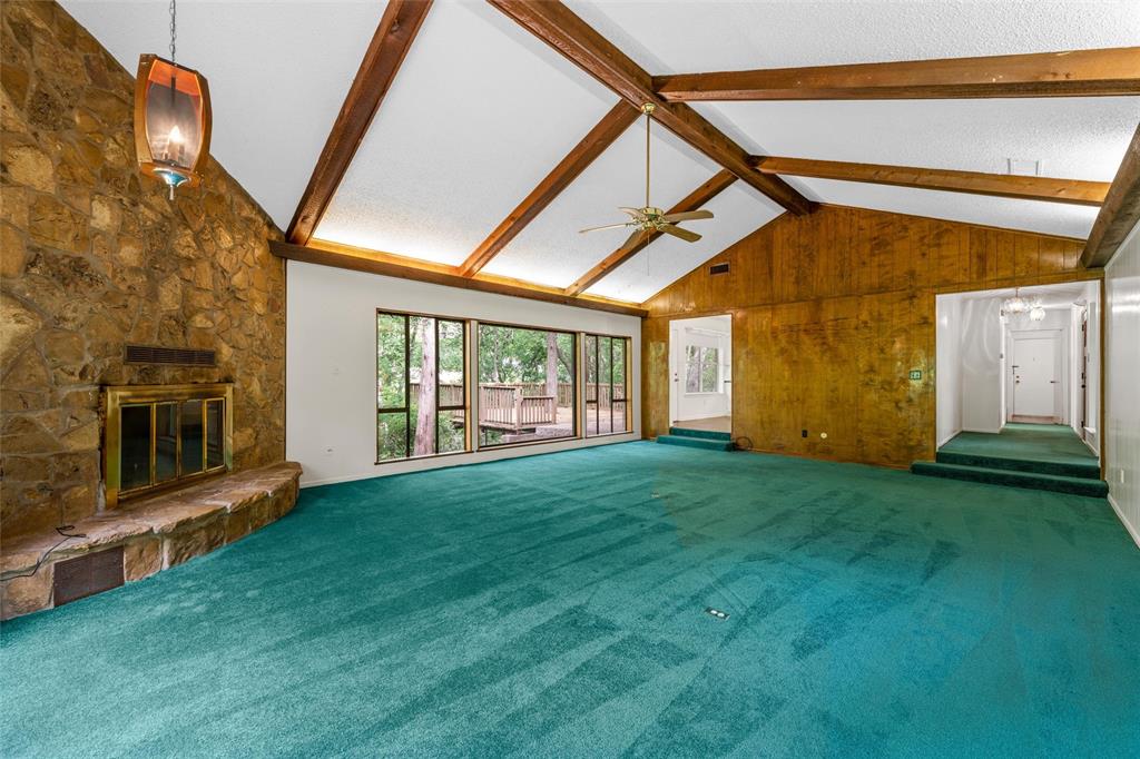 7821 Tallahassee Road Woodway, TX 76712 - Photo 6 of 31 a view of an empty room with windows and fireplace