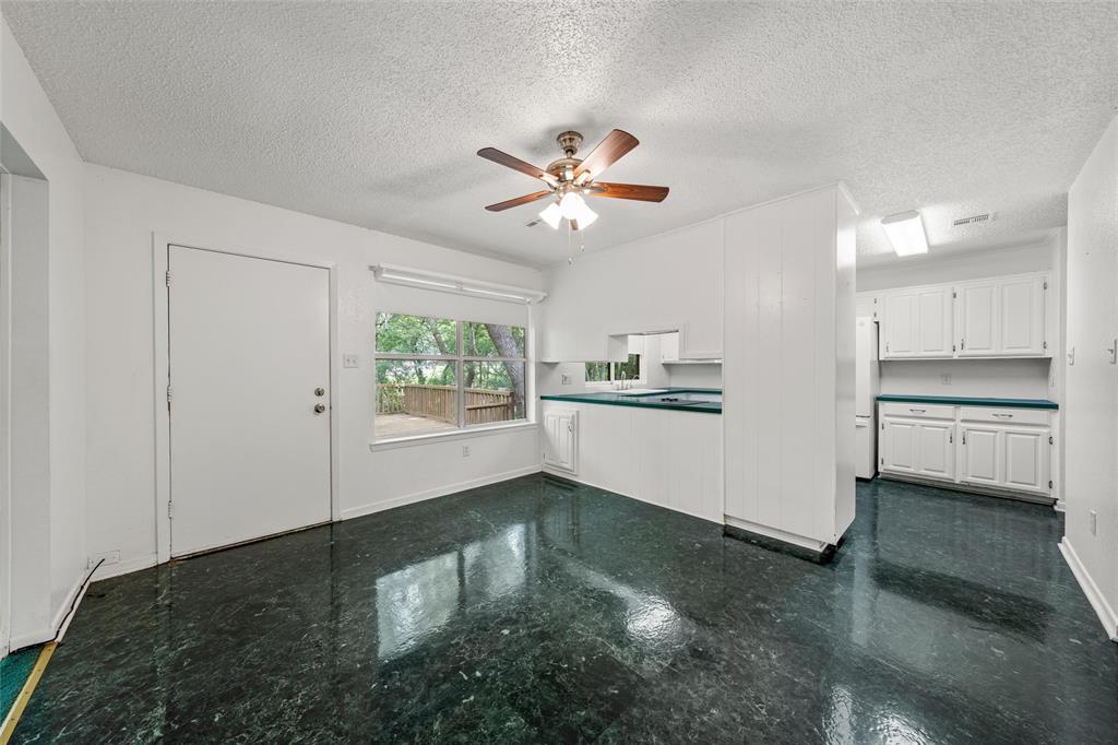 7821 Tallahassee Road Woodway, TX 76712 - Photo 8 of 31 a view of an empty room with kitchen and window