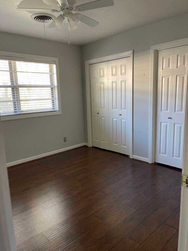 2305 Linwood Lane Bay City, TX 77414 - Photo 7 of 13 an empty room with wooden floor fan and windows