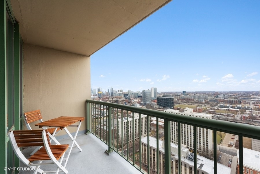 111 West Maple Street, Unit 2611 Chicago, IL 60610 - Photo 11 of 11 a view of a balcony with furniture
