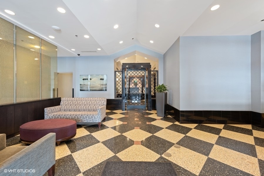 111 West Maple Street, Unit 2611 Chicago, IL 60610 - Photo 3 of 11 a living room with a rug and a table