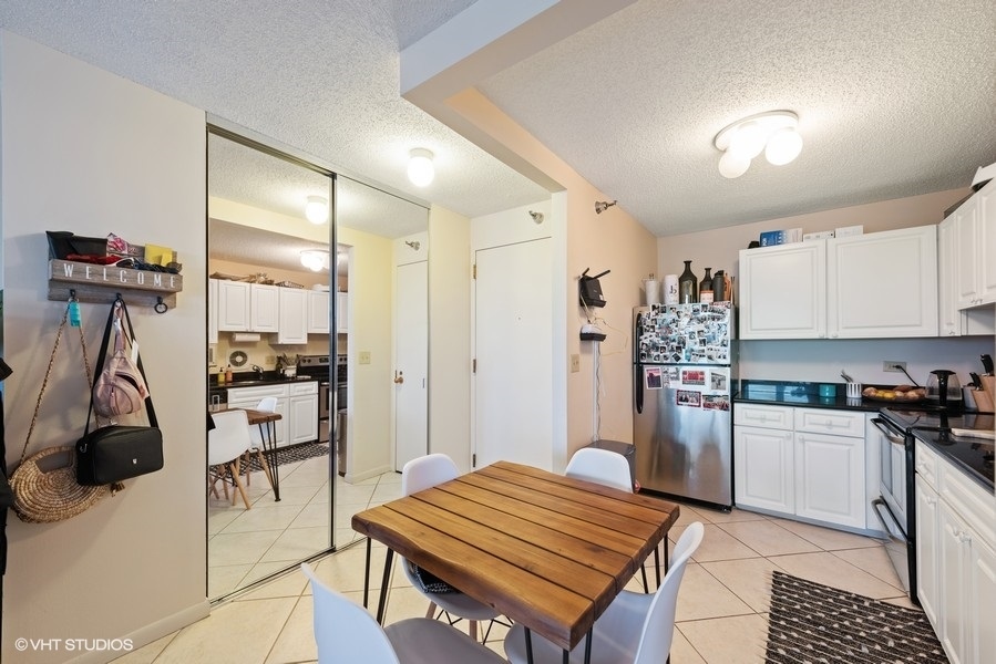 111 West Maple Street, Unit 2611 Chicago, IL 60610 - Photo 7 of 11 a kitchen with a sink appliances and cabinets