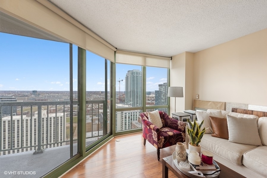 111 West Maple Street, Unit 2611 Chicago, IL 60610 - Photo 10 of 11 a living room with furniture and a floor to ceiling window