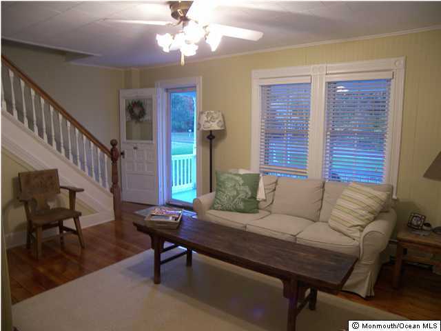 238 Maxim Road Howell, NJ 07731 - Photo 2 of 3 a living room with furniture and a chandelier