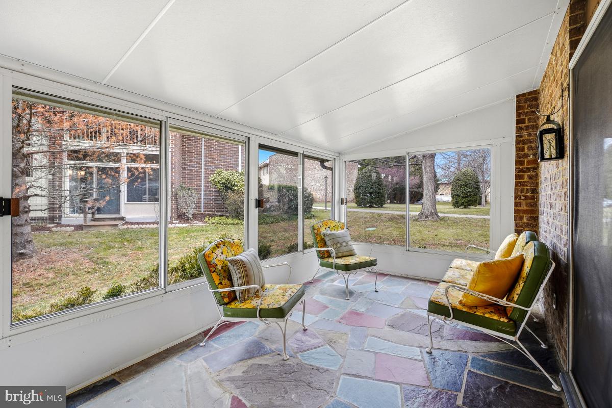 3436 Chiswick Court, Unit 45H Silver Spring, MD 20906 - Photo 18 of 30 a living room with furniture and a floor to ceiling window