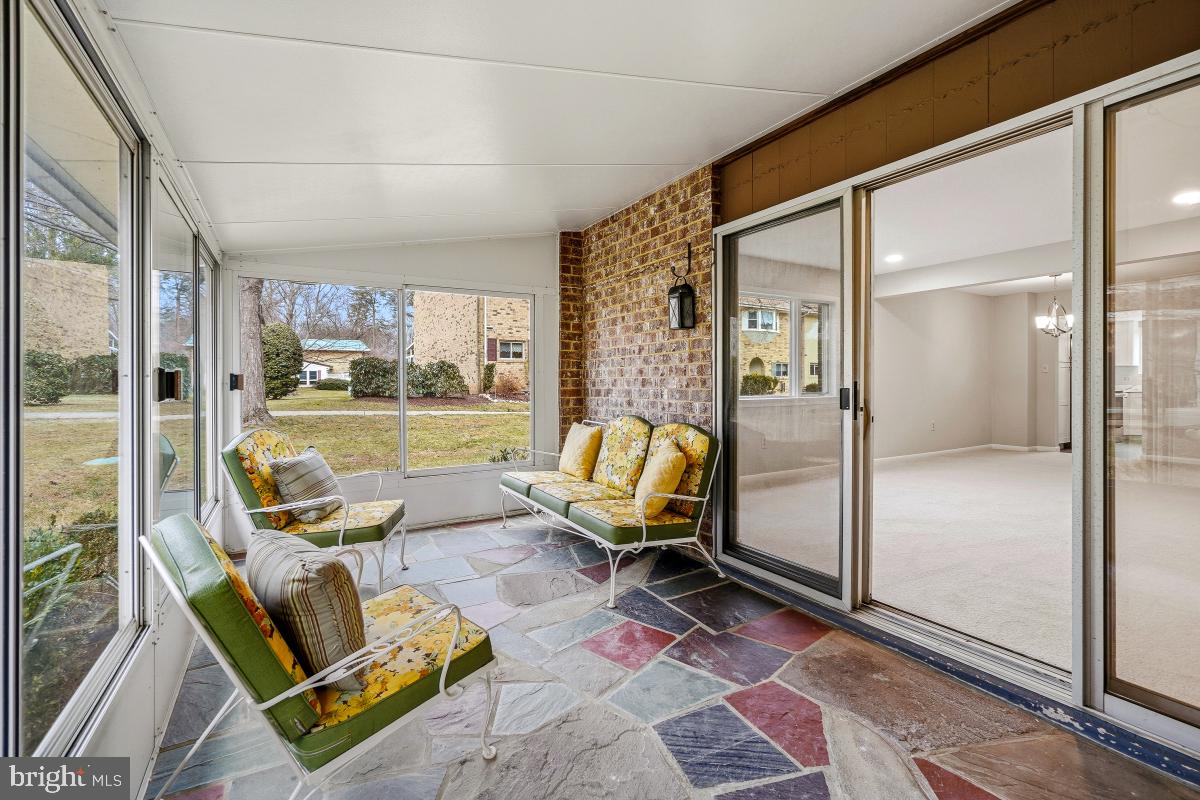 3436 Chiswick Court, Unit 45H Silver Spring, MD 20906 - Photo 19 of 30 a living room with furniture and a floor to ceiling window