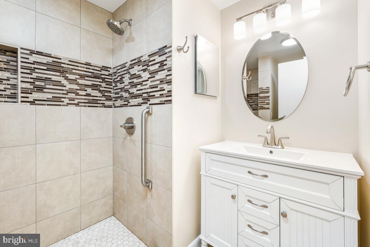3436 Chiswick Court, Unit 45H Silver Spring, MD 20906 - Photo 25 of 30 a bathroom with a sink a vanity and a mirror