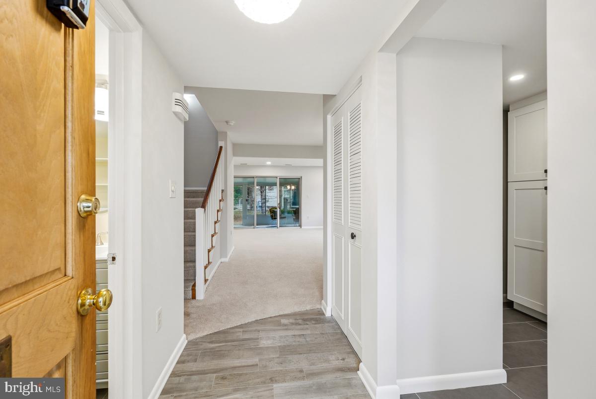 3436 Chiswick Court, Unit 45H Silver Spring, MD 20906 - Photo 3 of 30 a view of a hallway with wooden floor and windows