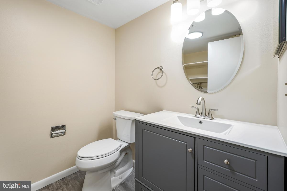 3436 Chiswick Court, Unit 45H Silver Spring, MD 20906 - Photo 5 of 30 a bathroom with a toilet a sink and mirror