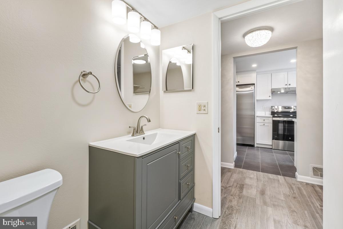 3436 Chiswick Court, Unit 45H Silver Spring, MD 20906 - Photo 6 of 30 a bathroom with a toilet sink and mirror