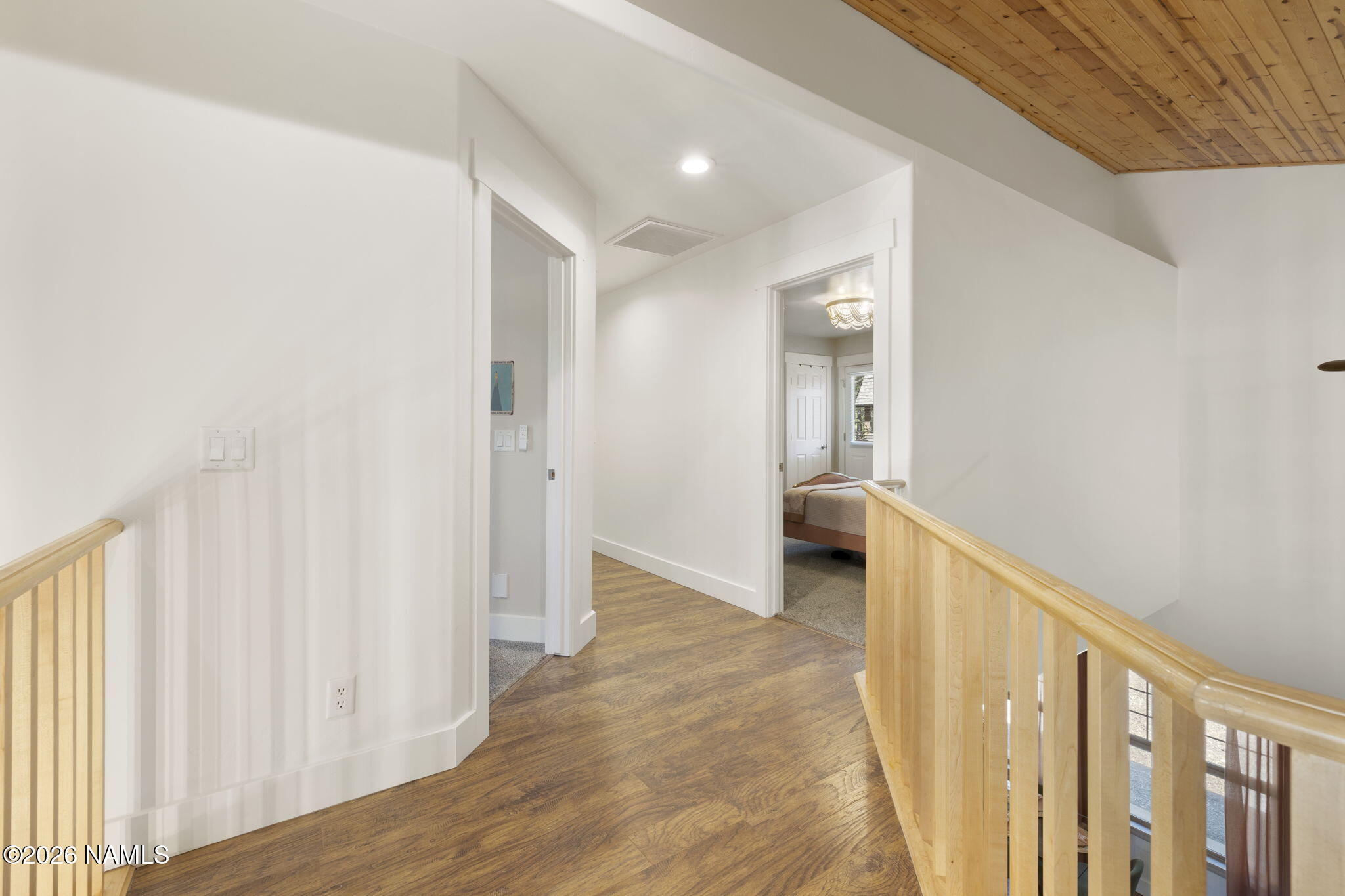 3495 West Lead Rope Flagstaff, AZ 86005 - Photo 33 of 49 a view of a hallway with wooden floor and cabinet