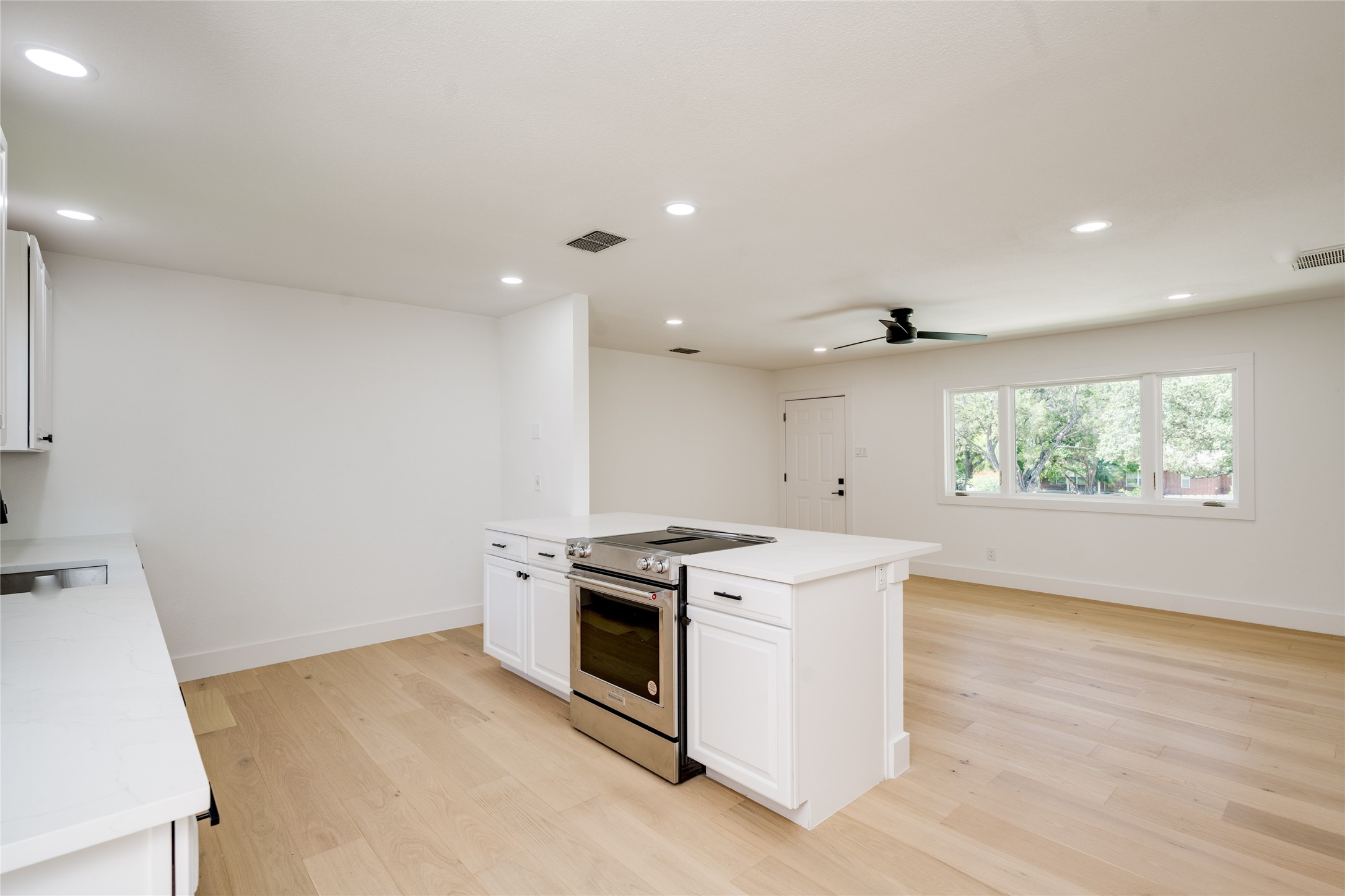 1928 Miles Avenue, Unit 1 Austin, TX 78745 - Photo 11 of 28 a kitchen that has a sink a stove and a window